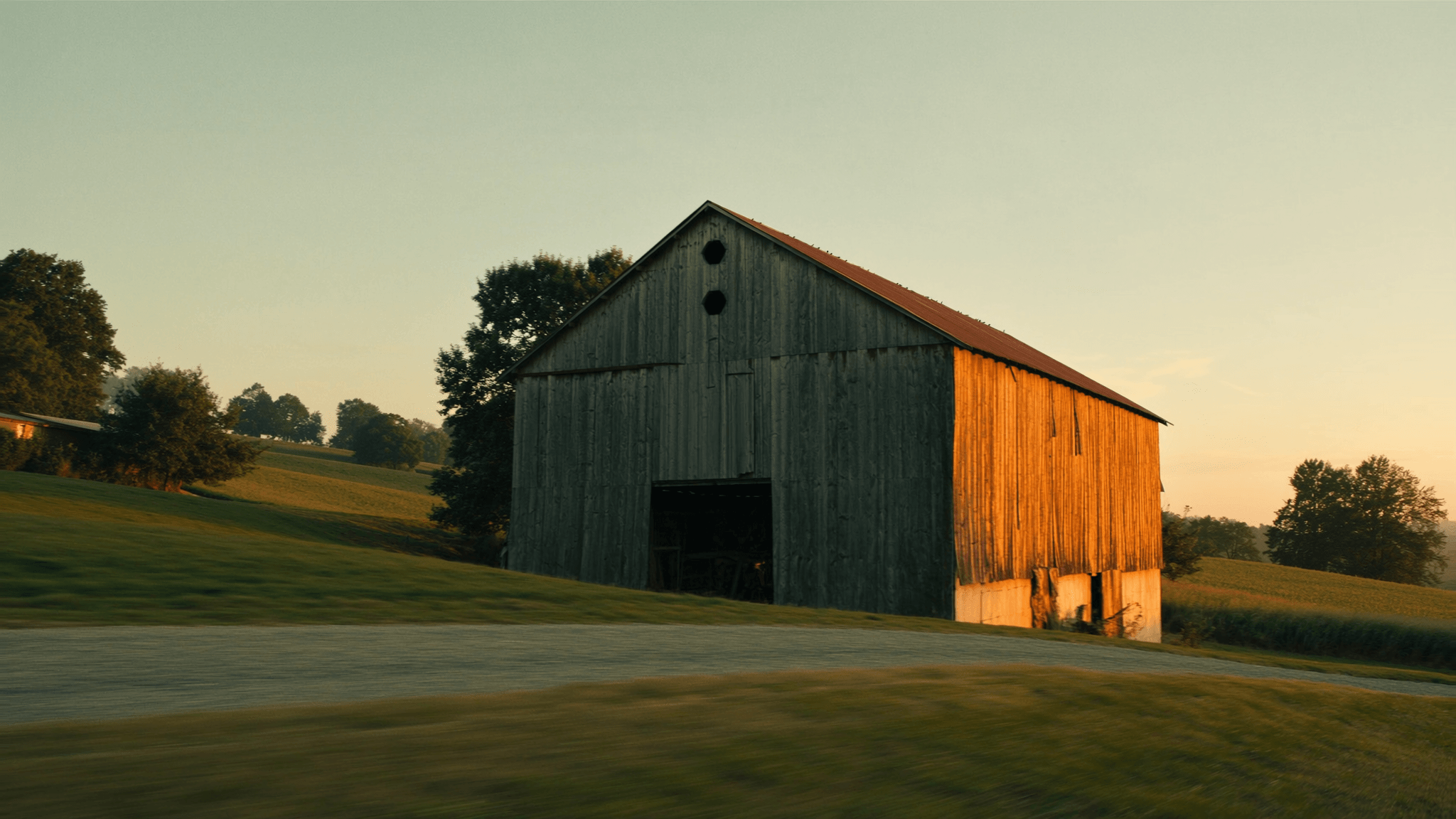 Weathered Kentucky tobacco barn at golden hour