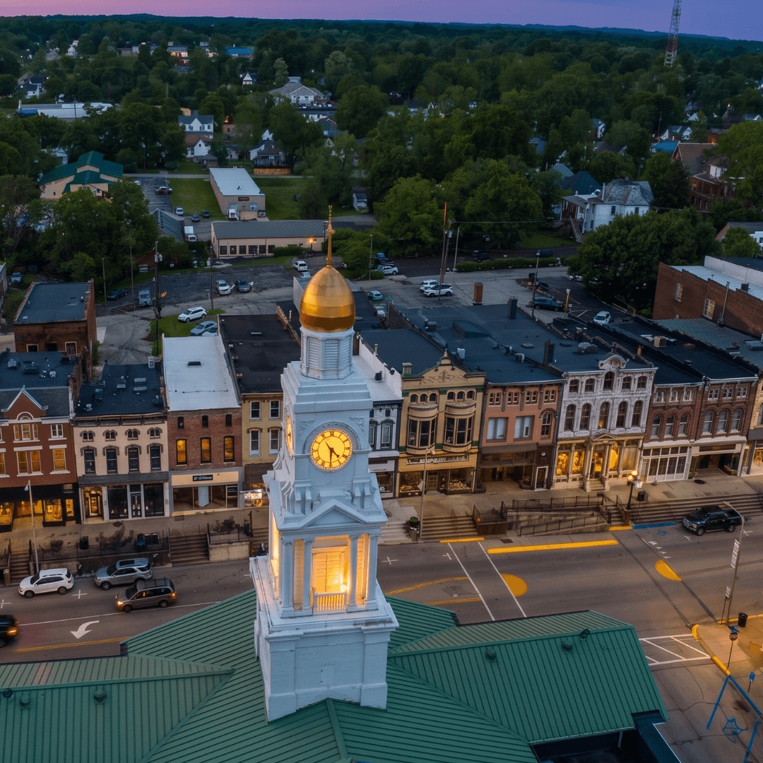 Downtown Winchester, Kentucky at dusk, with the gold-domed Clark County courthouse anchoring Main Street
